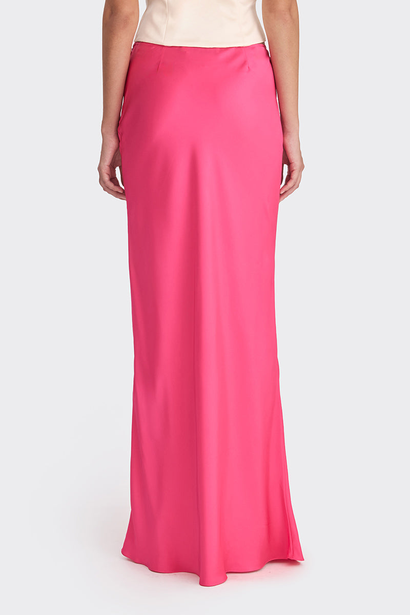 Hot pink low waist maxi skirt by Stolen Stores, featuring a flowy design and comfortable fit, shown on a model.