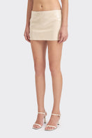 Beige low-waist sequin mini skirt by Stolen Stores, featuring shimmering sequins and a fitted, stylish silhouette.