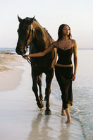 Black Nana Jacqueline Luciana maxi dress with ring cutout design, elegant and flowing fabric perfect for summer occasions.