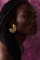 Gold wavy hoop earrings by Maria Frering featuring a stylish, textured design perfect for everyday wear.