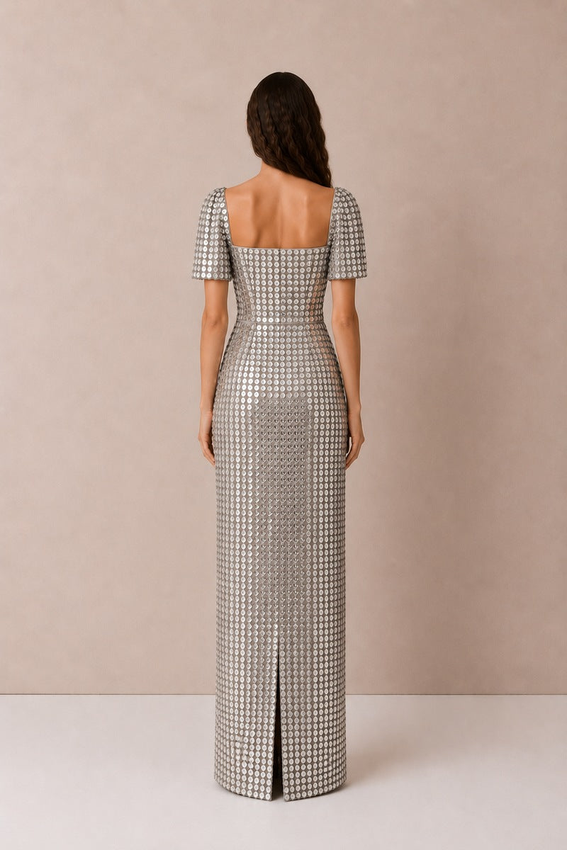 Silver Lujain sequin gown by Nihan Peker featuring intricate sequin details and elegant flowing fabric.