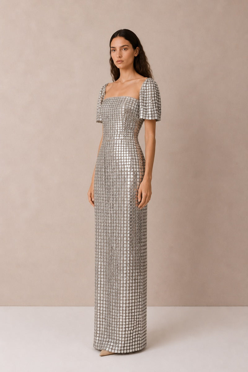 Silver Lujain sequin gown by Nihan Peker featuring intricate sequin details and elegant flowing fabric.
