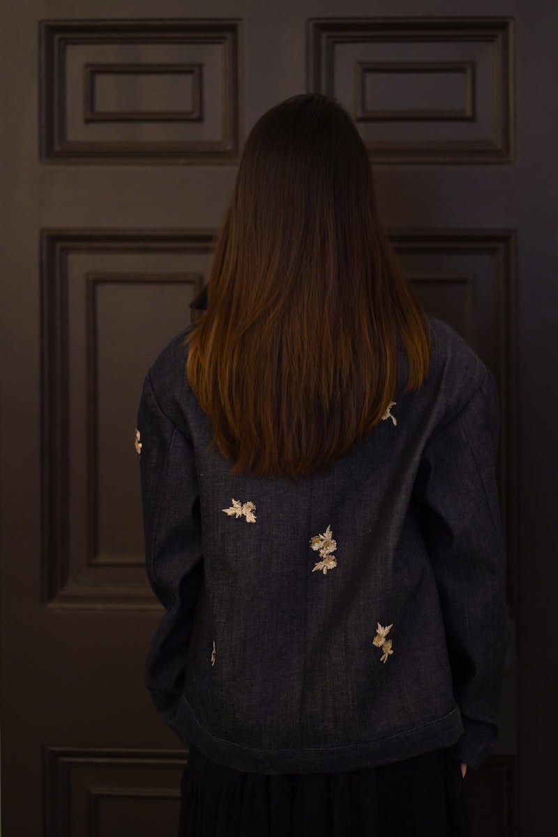 Nadya Shah LUMIN dark denim jacket displayed from the back, featuring classic stitching and a fitted style.