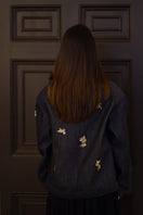Nadya Shah Lumin Dark Denim Jacket shown from the back, featuring classic denim design and tailored fit.