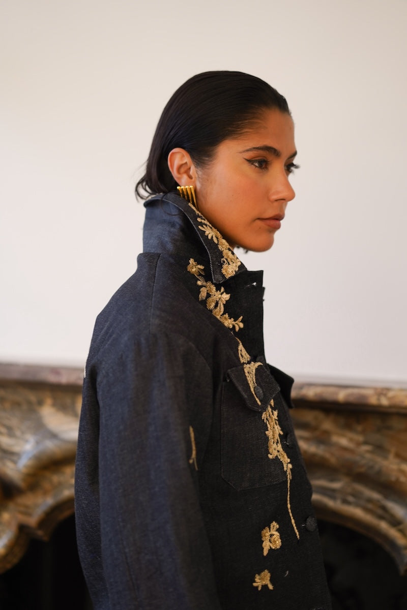 Nadya Shah Lumin Dark Denim Jacket shown from the side, featuring classic denim style, button closures, and a fitted silhouette.