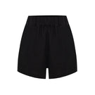 Labeca Luna black linen shorts displayed on a model, showcasing lightweight, breathable fabric and casual style.