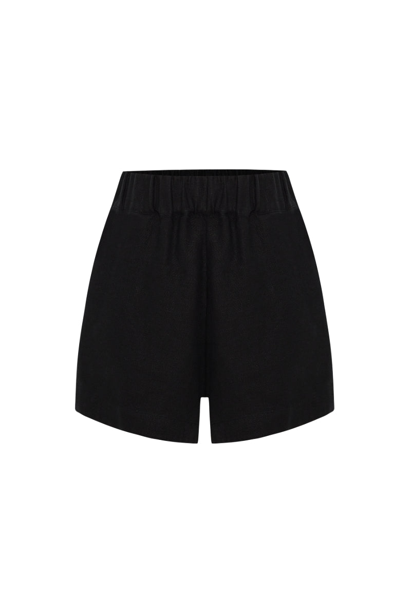 Labeca Luna black linen shorts displayed on a model, showcasing lightweight, breathable fabric and casual style.