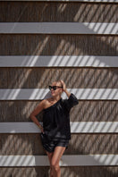 Labeca Luna Black Linen Shorts displayed on a model, showcasing lightweight, comfortable black linen shorts for casual wear.