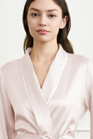 LUNA women's silk robe by MANITO, soft and luxurious, displayed on a hanger with flowing fabric and delicate lace trim.