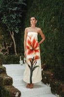 Nana Gotti Lunara maxi dress with flowing fabric, V-neckline, and adjustable straps, displayed on a hanger.