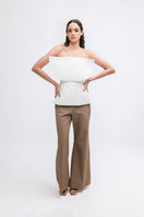 ANA + MARIA LUNE ivory top, soft fabric, fitted design, with a round neckline and long sleeves, displayed on a hanger.