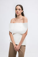 Elegant ivory LUNE top by ANA + MARIA displayed on a model, showcasing its stylish design and soft fabric.