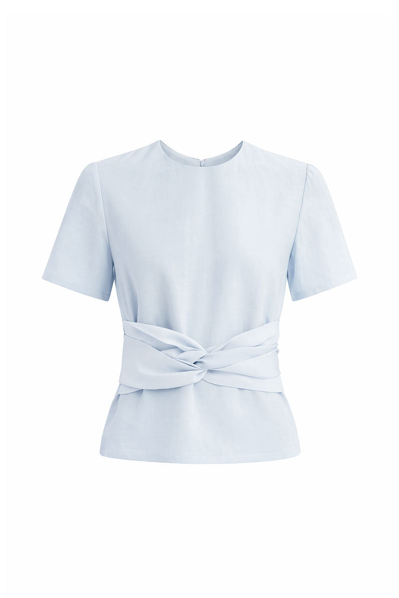 Baby blue Maylé Vásquez Lunera Top displayed on a hanger, showcasing its stylish design and soft fabric.