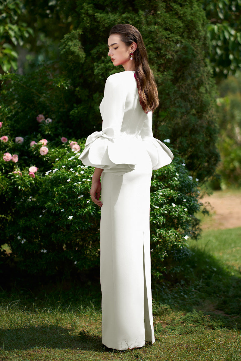 Elegant I.H.F column gown with trapeze neckline and rose draped three-quarter sleeves, featuring a sleek, flowing silhouette.