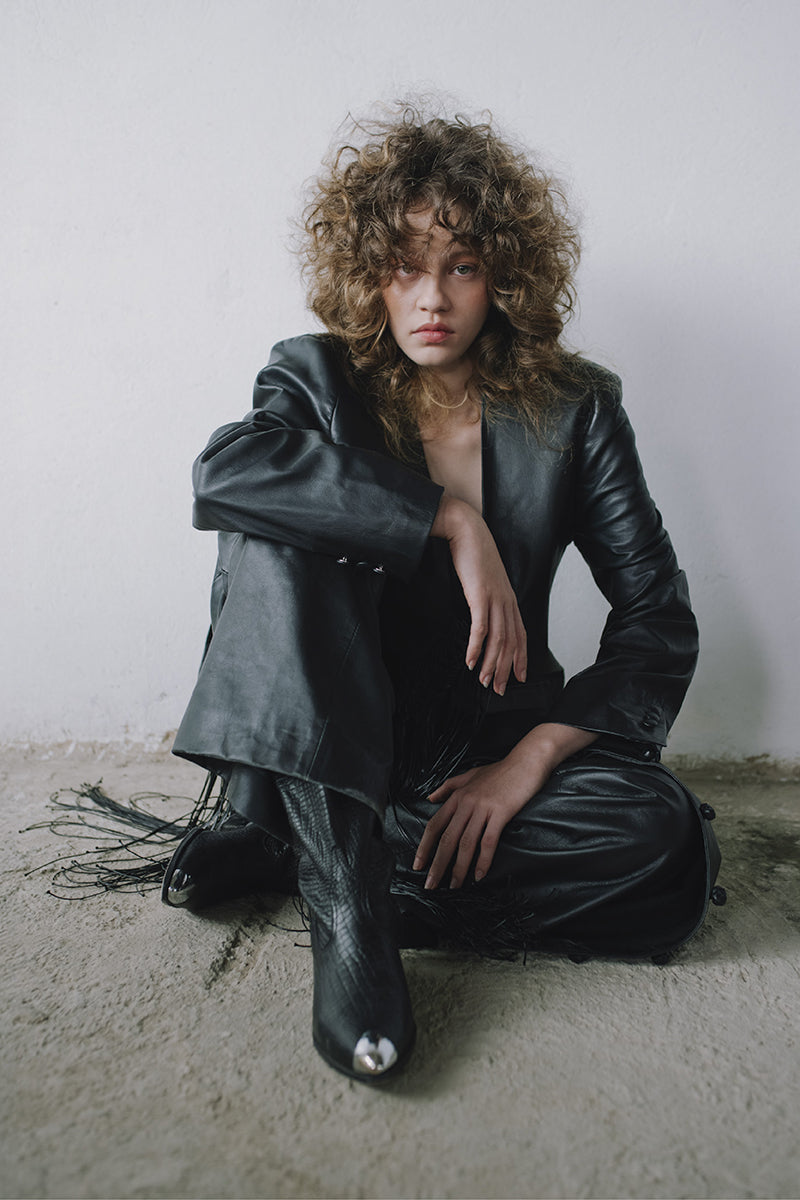 Black leather macramé blazer by MAZ Manuela Álvarez featuring intricate macramé details and tailored fit.