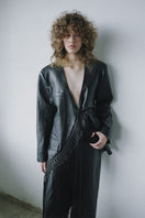 Black leather macramé blazer by MAZ Manuela Álvarez featuring intricate macramé details and tailored fit.