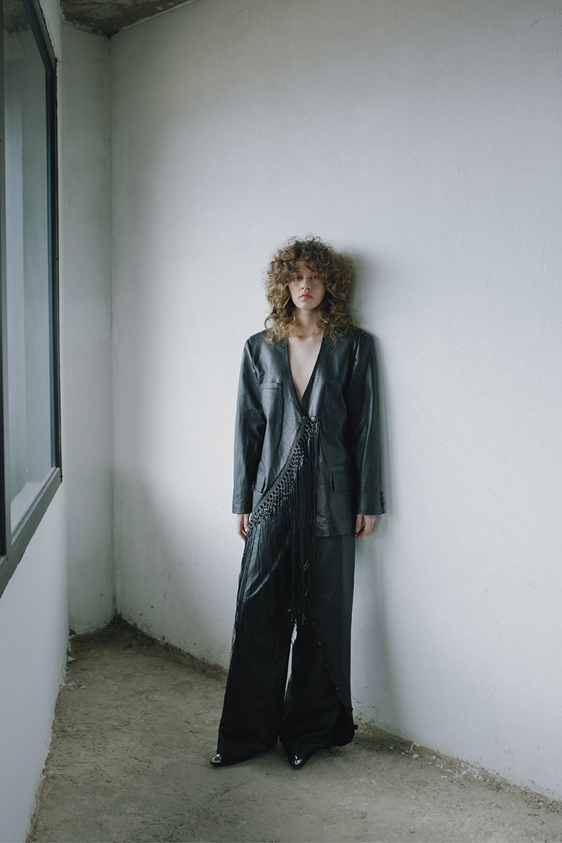 Black leather macramé blazer by MAZ Manuela Álvarez featuring detailed macramé design and tailored fit.