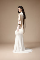 Elegant Jenny K Tran Marai gown in off-white and beige, featuring flowing fabric and sophisticated design.