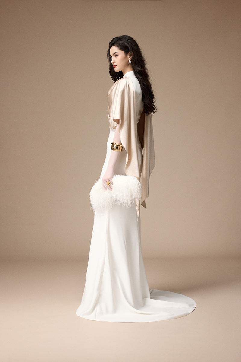 Elegant Jenny K Tran Marai gown in off-white and beige, featuring flowing fabric and sophisticated design.
