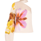 Tinta Latina Maranta floral blouse with colorful, patterned fabric and long sleeves, displayed on a hanger.