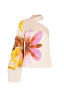 Tinta Latina Maranta floral blouse with colorful, patterned fabric and long sleeves, displayed on a hanger.