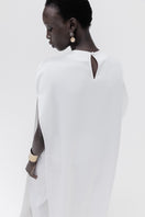 Studio NK ivory marble cape top featuring a flowing, elegant design with marble-inspired pattern and lightweight fabric.