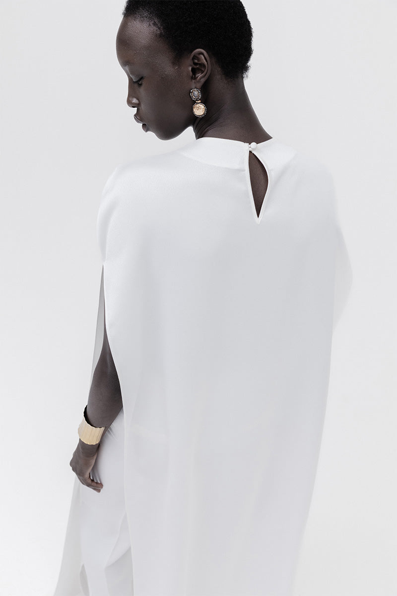 Studio NK ivory marble cape top featuring a flowing, elegant design with marble-inspired pattern and lightweight fabric.