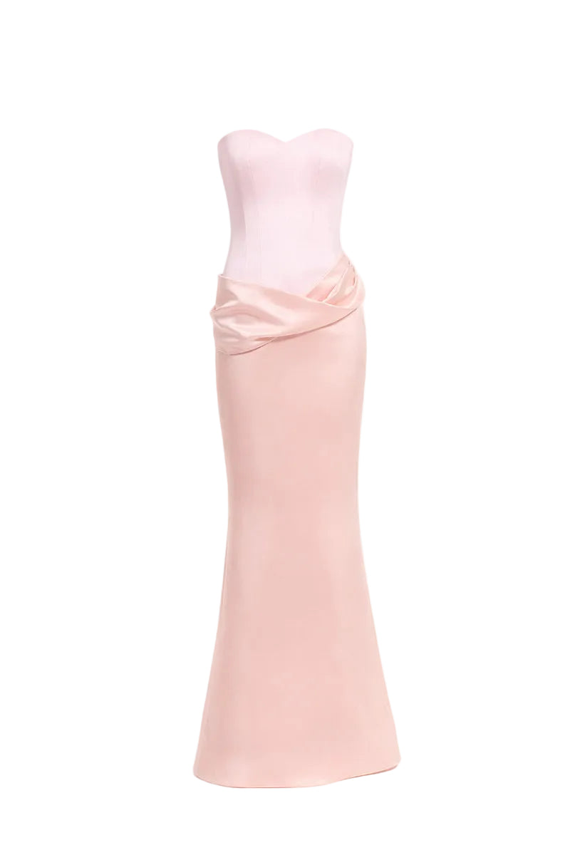 Blush pink MARIVEN maxi dress by URBAN MUSE displayed on a hanger, showcasing its flowing fabric and elegant design.