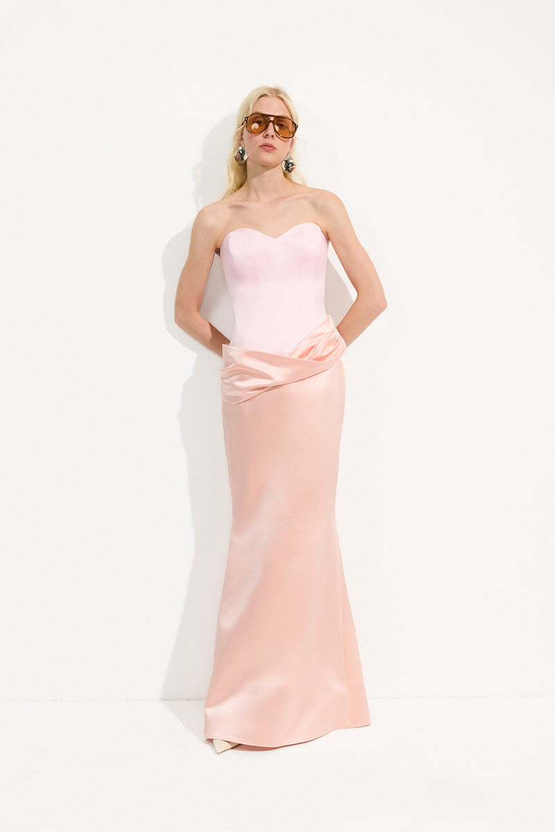 Urban Muse Mariven blush pink maxi dress displayed on a hanger, showcasing flowing fabric and elegant design.