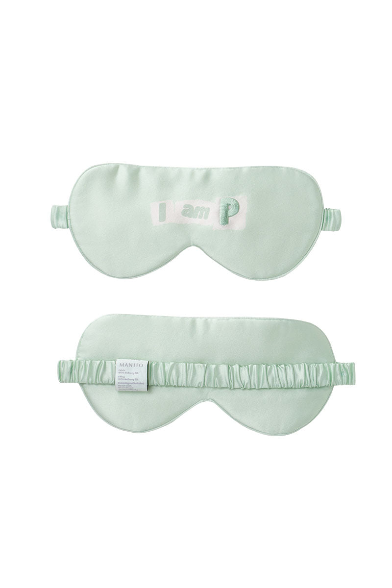 Green MBTI silk eye mask by MANITO featuring the Myers-Briggs Type Indicator logo on smooth silk fabric.