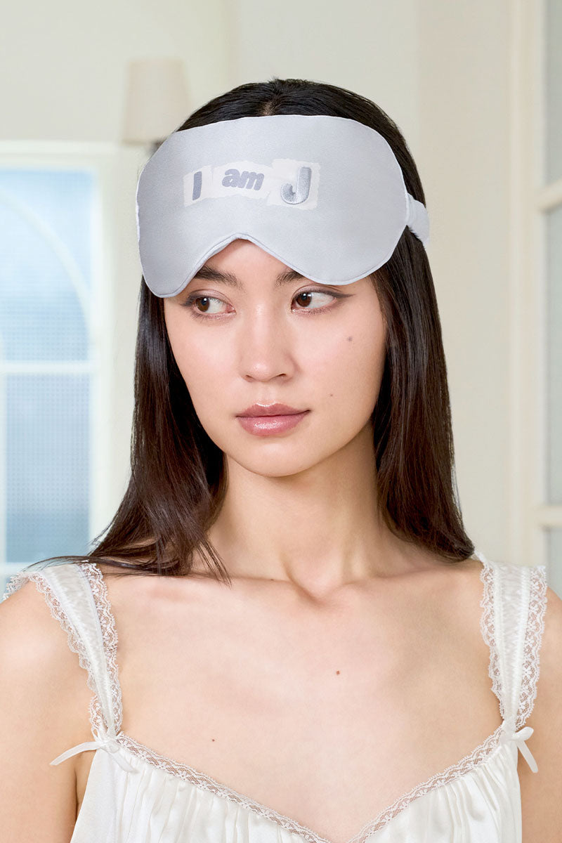 Gray MBTI silk eye mask by MANITO, soft and comfortable sleep accessory with detailed MBTI logo design.