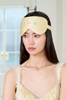 Yellow MANITO MBTI silk eye mask with soft fabric and embroidered MBTI logo, designed for comfortable sleep and relaxation.