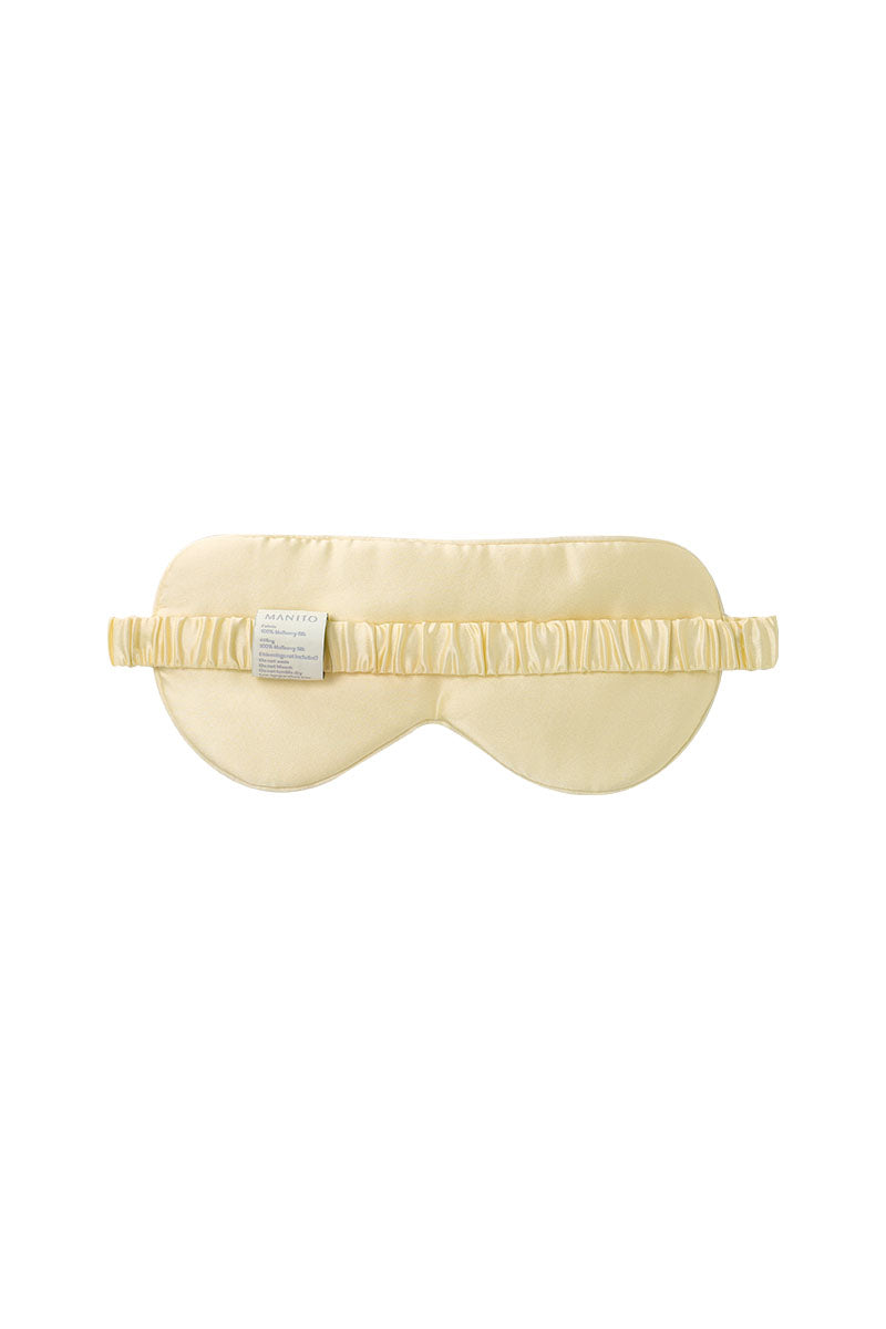 Yellow silk eye mask by MANITO featuring the MBTI design, soft and comfortable for restful sleep or relaxation.