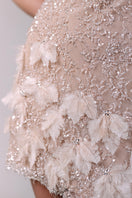 Champagne-colored embroidered feather mini dress by Monika Dimova, featuring intricate feather embellishments and elegant design.