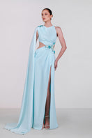 Blue embellished cape gown by Monika Dimova, featuring intricate embroidery and elegant flowing fabric.