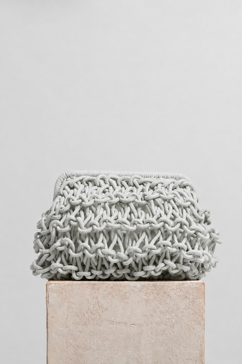 Medium teal rope clutch bag by FolkLore The Label with a textured rope design and compact, stylish silhouette.