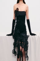 Black sheer mini dress with floral appliqués by Malva Florea, featuring a fitted silhouette and delicate floral detailing.