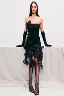 Black mini dress by Malva Florea featuring floral appliqué details and sheer fabric, designed for a stylish, modern look.