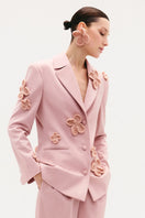 Malva Florea classic hourglass jacket with crochet floral appliqués in powder, showcasing elegant design and intricate detailing.
