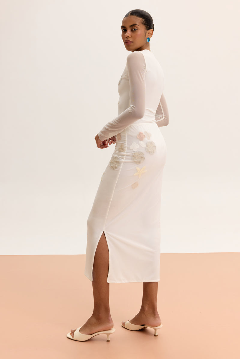 Long-sleeved sheer bodysuit from Malva Florea, lightweight and fitted, shown in white with delicate fabric details.