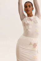 Long-sleeved sheer bodysuit by Malva Florea featuring a fitted design and lightweight, see-through fabric in white.