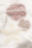 Long-sleeved sheer bodysuit with floral appliques by Malva Florea, showing delicate lace and elegant design details.