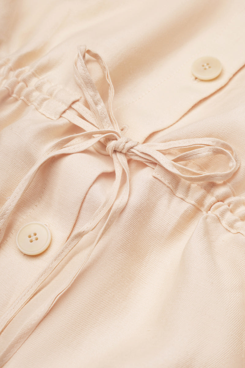 Light blue sleeveless button-up blouse by Malva Florea, showing the front view with a classic collar and button closure.