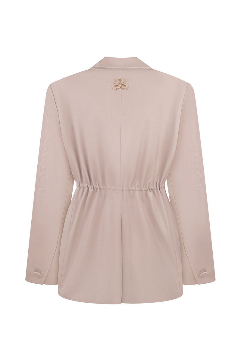 Back view of MALVA FLOREA relaxed fit blazer with flower detail, stylish jackets featuring a tailored design and floral accents.