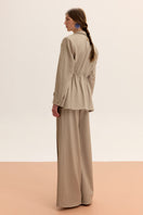 Bias-cut pants by Malva Florea featuring a flowing fabric design and a relaxed fit, shown on a neutral background.