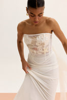 White high-waisted column midi skirt by Malva Florea, shown from the side with smooth fabric and elegant silhouette.