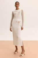 White high-waisted embellished pencil midi skirt by Malva Florea, showcasing intricate bead and embroidery details.