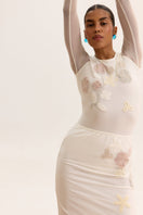 White high-waisted embellished pencil midi skirt by Malva Florea, featuring intricate decoration and a sleek, fitted silhouette.
