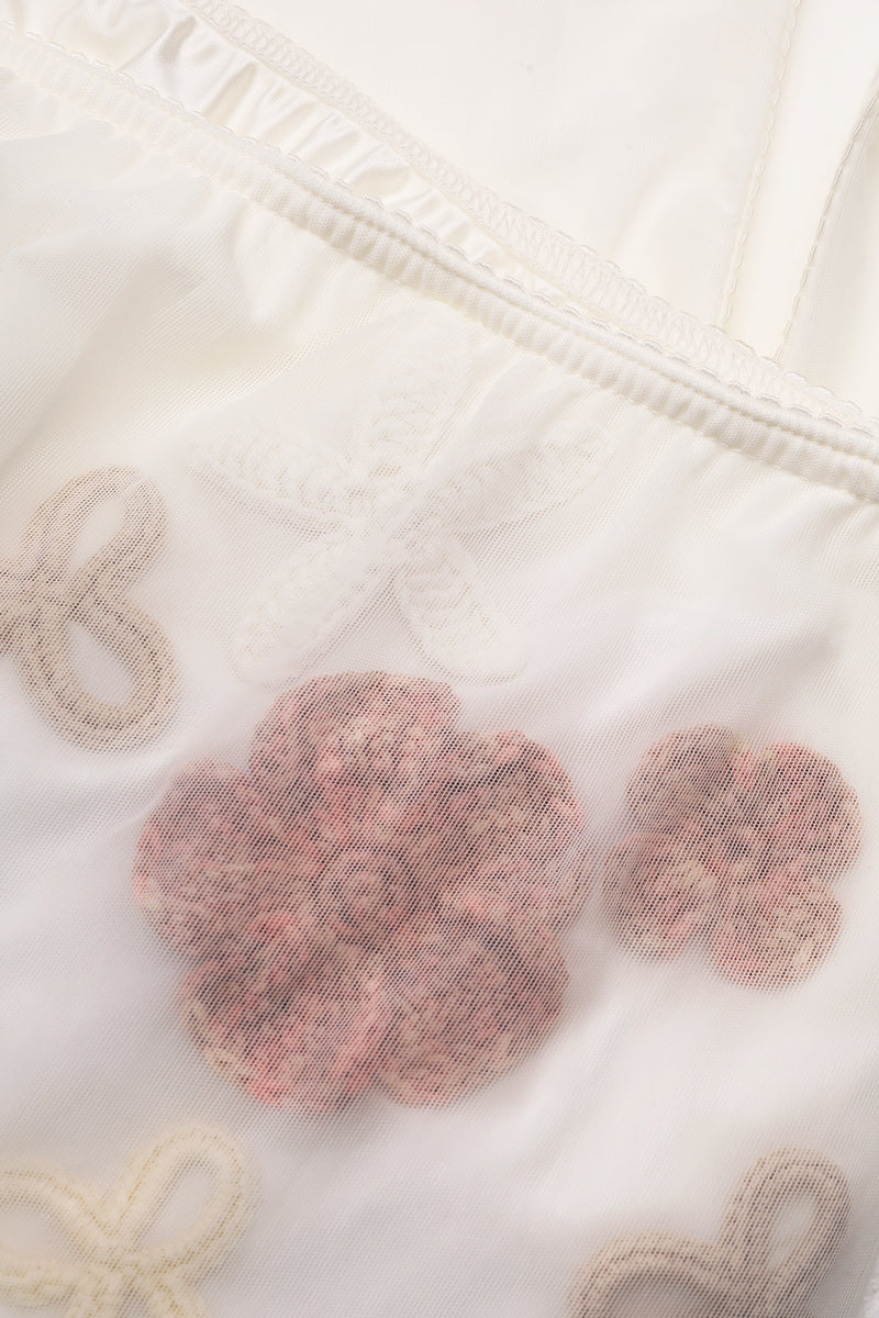 White high-waisted embellished pencil midi skirt by Malva Florea with floral appliques and intricate detailing.