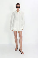 Relaxed-fit ivory blouse from Malva Florea, stylish shirt with flowy fabric and classic collar, shown on a hanger.